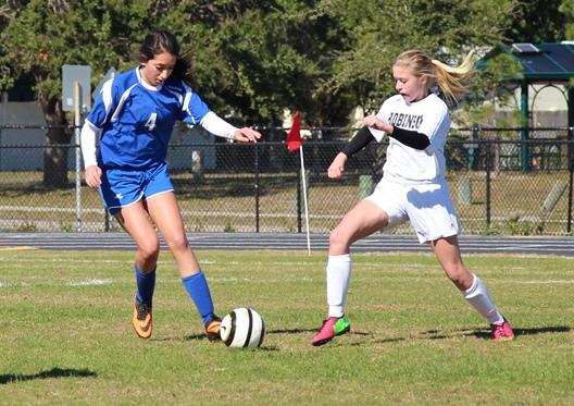 Freshman Knight Maggie OBrien passing the ball past a Seminole defender.