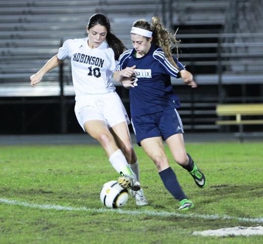 Hayden Jennewein dribbling past a Steinbrenner defender.