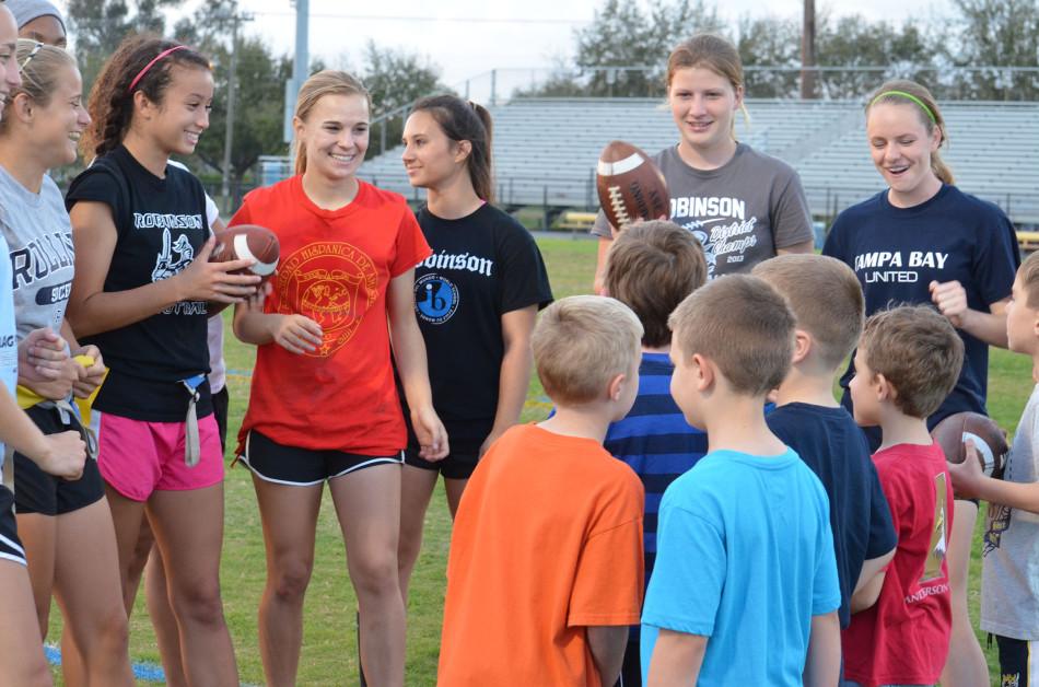 The Flag Football team at a previous volunteering event with cub scouts earning their flag football patch.