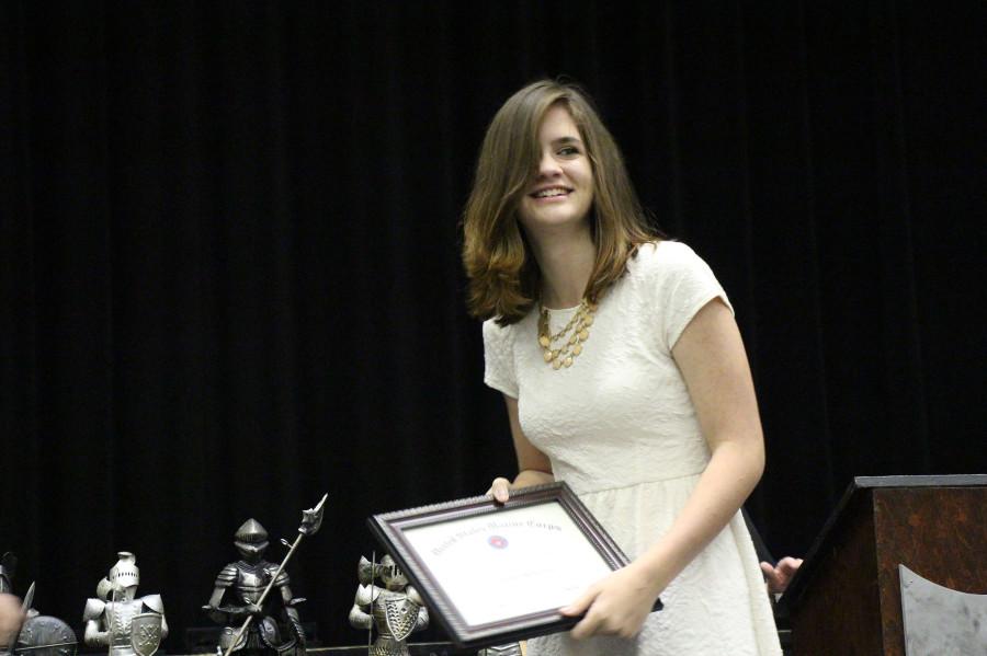 Senior+Lauren+Wheatley+receives+an+award+for+her+athletic+accomplishments+as+a+member+of+the+volleyball+team.