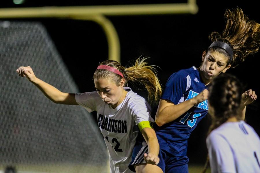 Captain Megan Bohan (16) comes up for a header with a Newsome defender at her side.