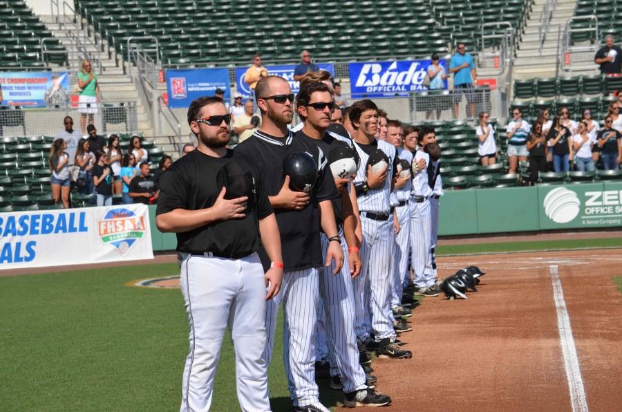 The Knights remove their caps for the Pledge of Allegiance during the state semifinal game in 2015 held at jetBlue park.