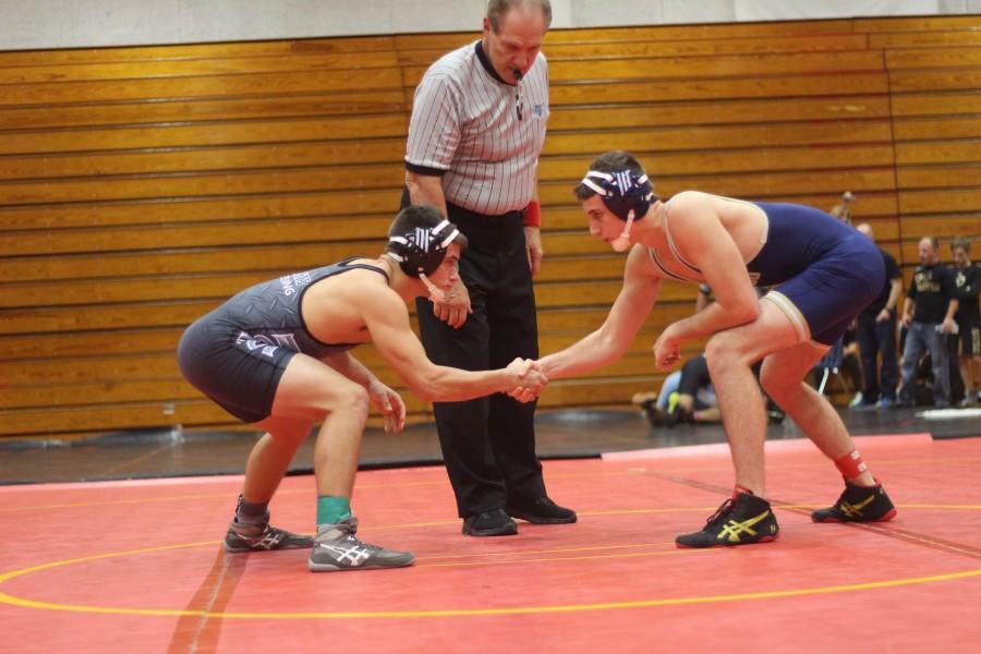 Keyton McCoy (16) shakes his opponents hand before the start of a match at the Leto Duals.