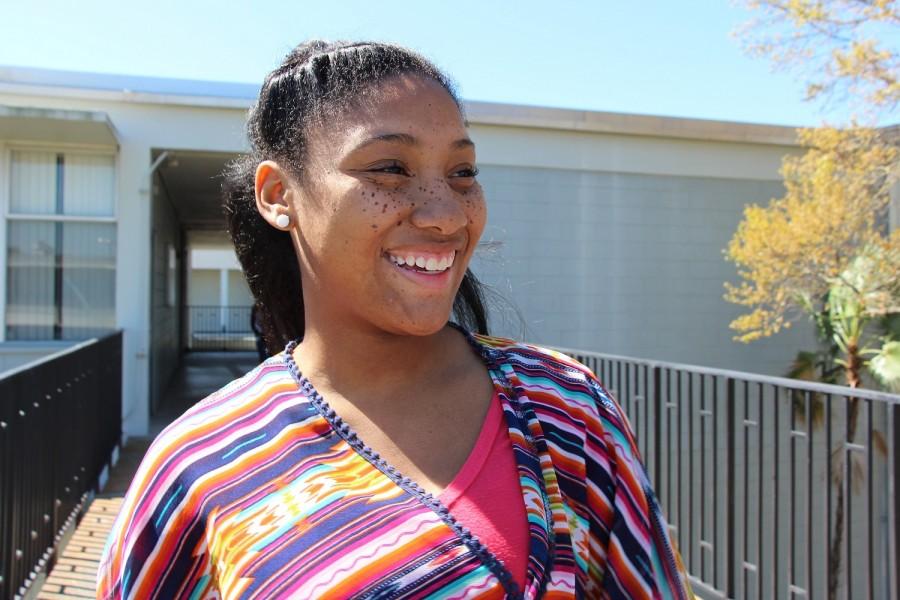 Sporting a tribal print shirt, Kristal Hill (18) laughs at a friend. Hill describes herself as energetic and colorful, like the clothing she chooses to wear.