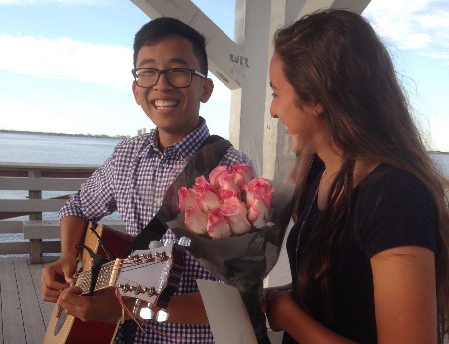 With flowers in hand, Natalia Ayoub (17) smiles at boyfriend Sean Tran (17) after he asked her to prom at the Ballast Point Pier.