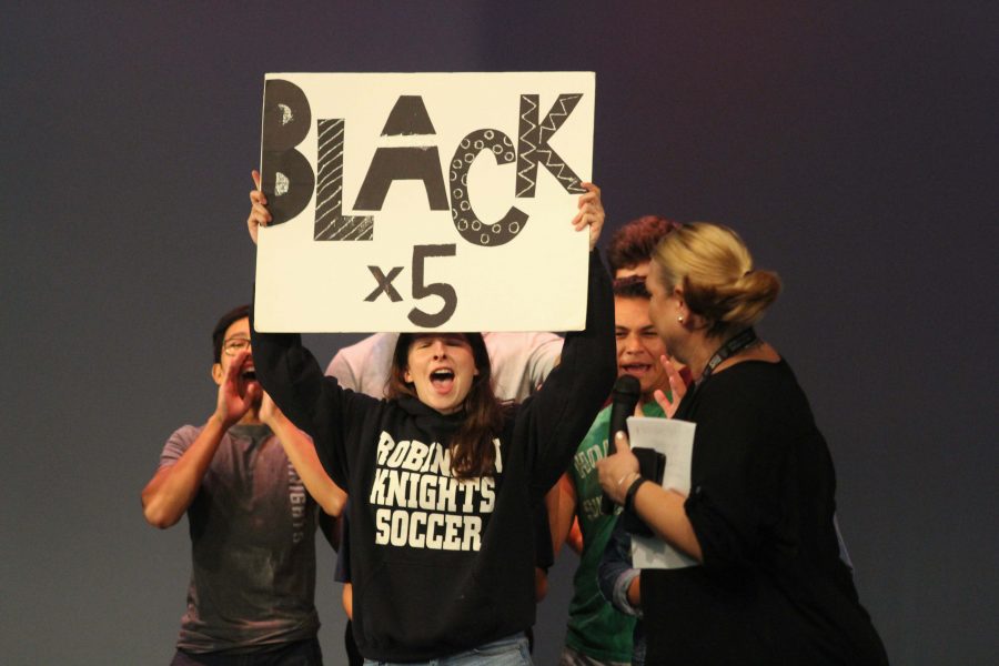 Student government seniors, led by Olivia Salzman (17), demonstrate to the freshmen the junior class spirit chant.