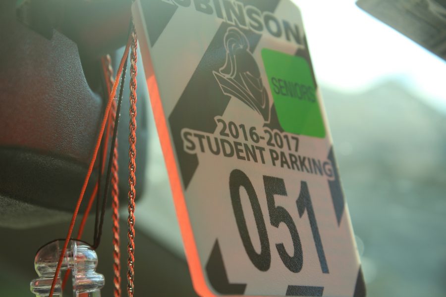 Robinson hang tags cost $20 and are required of all students who park their cars at school. Seniors receive a green senior sticker which allows them to park in senior-only spots.