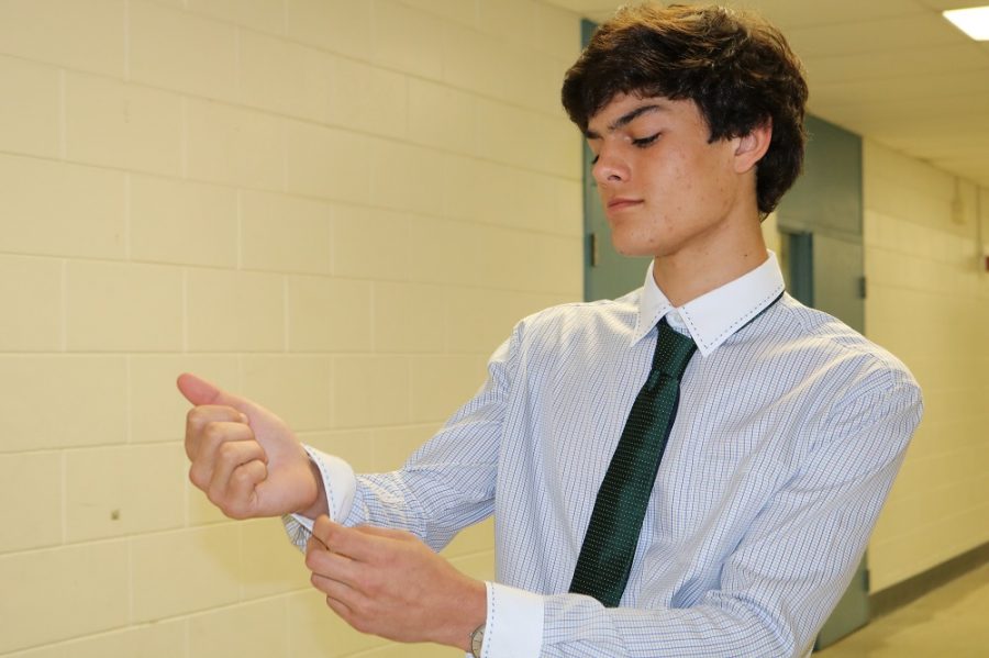 Lorenzo Migliara (19) adjusts the dress shirt he wore for lacrosse.