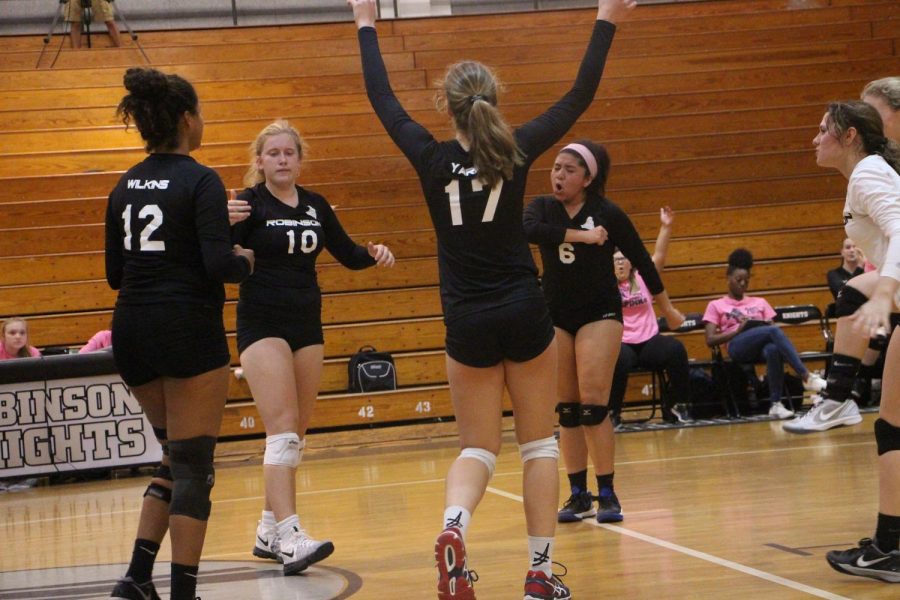 The Lady Knights cheer after they get a point against Newsome on Wednesday.