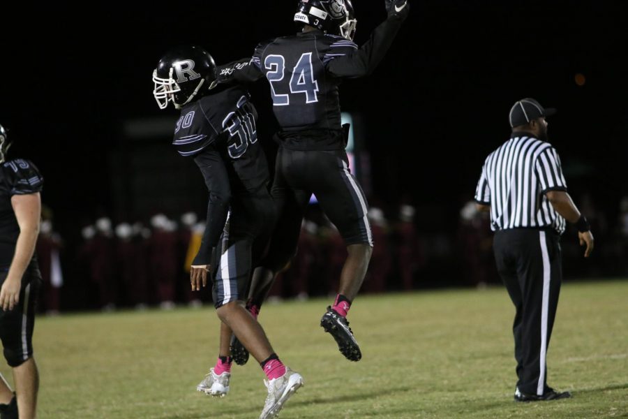 Tevin Fordham (18) and Christopher Rolack (18) chest bump after an interception for the Knights. 