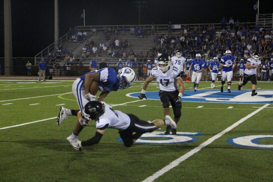Eann Johnson (18) makes the tackle against Jesuit on Friday night.