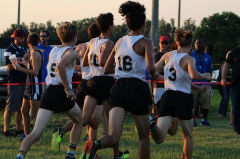 The 2017 boys cross country team races to the finish line.