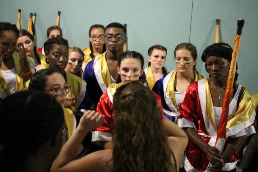 The Starlets receive feedback from Starlets Director Siara Espejo after performing in the courtyard of Newsome High School. The Newsome competition was moved indoors due to the weather and the band could not march their complete show,