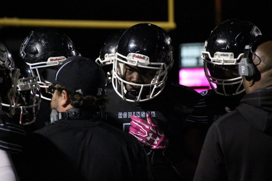 Quinton Lane 19  lines up in the huddle during the Jefferson vs. Robinson game last Friday night. The Knights face Bloomingdale tonight in the final game of the season.