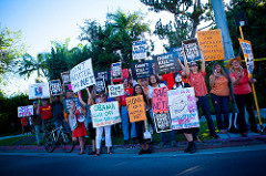 Protesters raise signs in favor of net neutrality at a protest in 2014. 