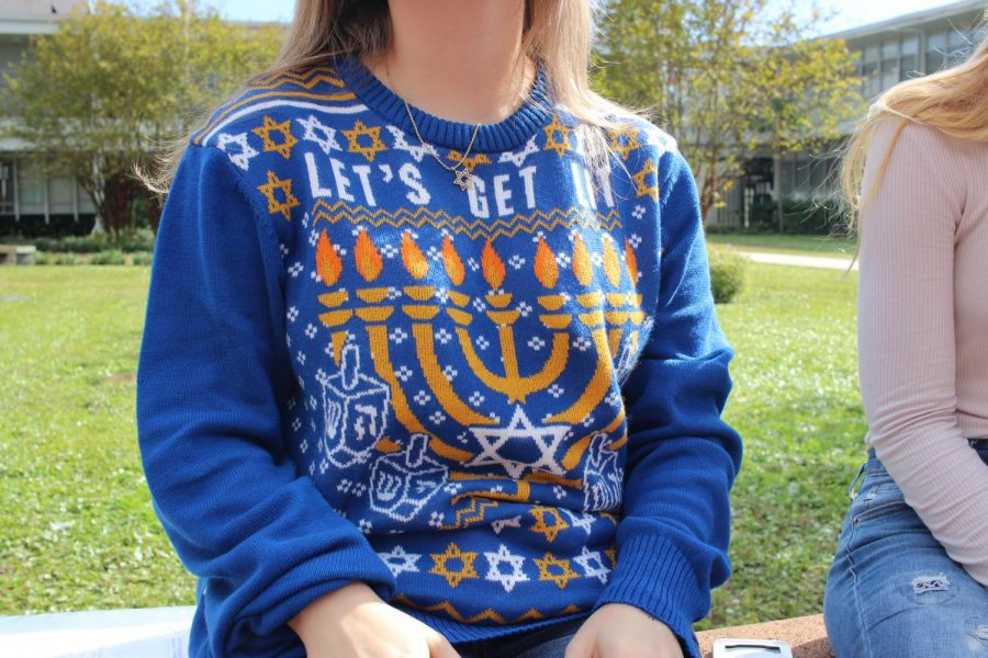Sam Bieniasz (18) shows of her Hanukkah sweater. 