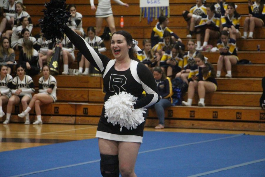 Mia Blumenthal (19) encourages the crowd  to get loud during the cheering part of the performance.