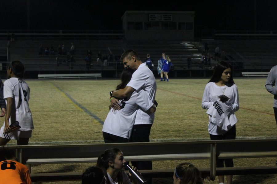 Captain Elisa Toghranegar (18) hugs Helms in his last game coaching as the Lady Knights fall 3-0 to Osceola.
