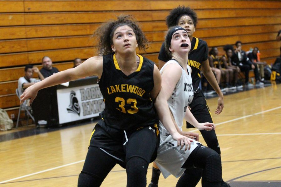 Center Anna Thomas (18) fights for a rebound in the Regional Finals match against Lakewood on Friday, Feb. 23.