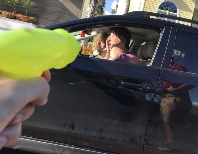 Nick Chesney (18) is eliminated from Water Wars, the senior water gun fight, while in his car. The photo was tweeted as proof of the teams kill.
