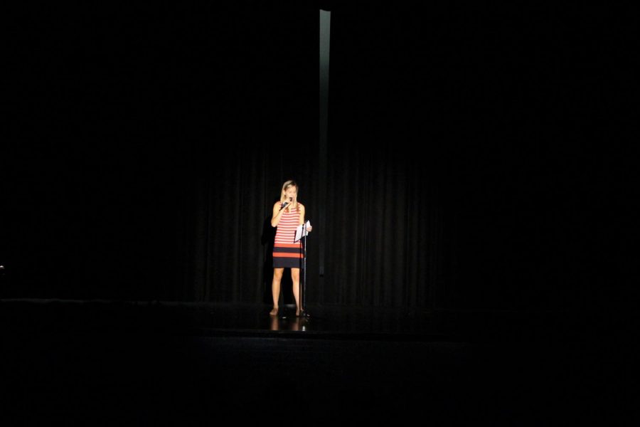 Carolina Cassedy (‘18) speaks in front of Robinson students prior to the performance of The Yellow Dress, a one-woman show to bring awareness to domestic abuse.