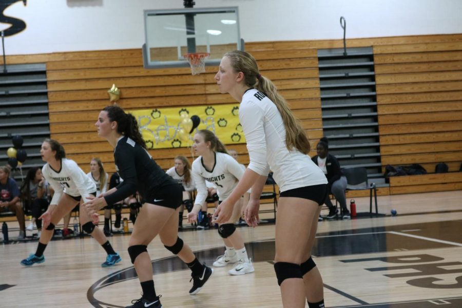 Kristin Werdine (19) and her teammates get ready as the ball is being served. 