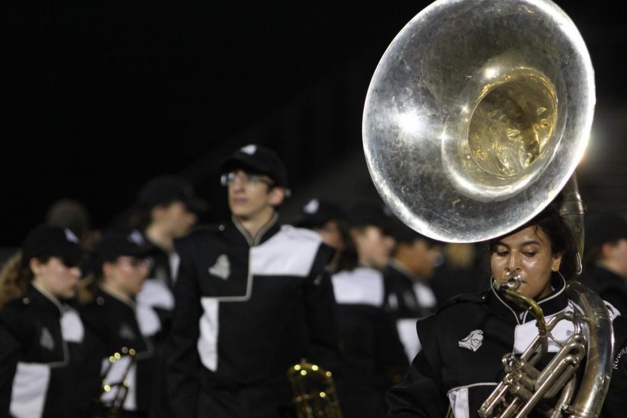 Mia Simmons (21) playing the french horn during halftime at the Spoto game.