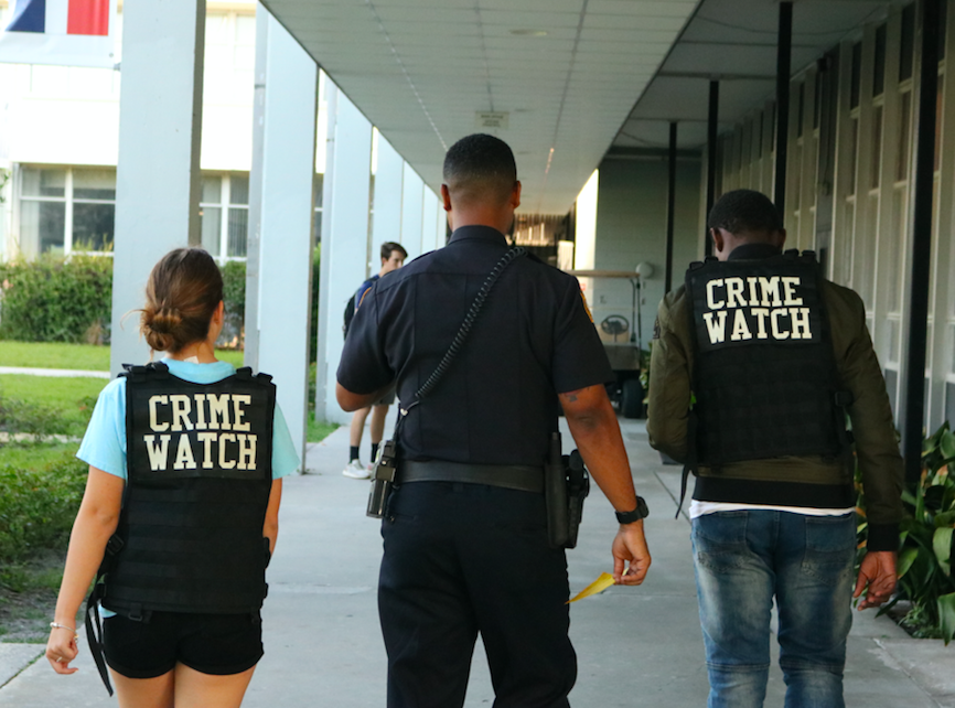 Officer Hester walks with students during the Crime Watch class.