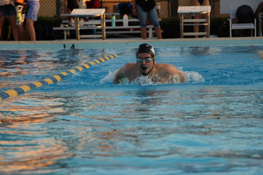 Nick Carlstedt (20) swims his last home race