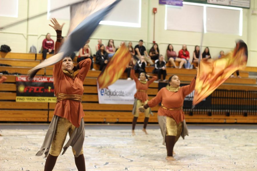 Members of the Robinson Colorguard perform a flag routine for a competition.
