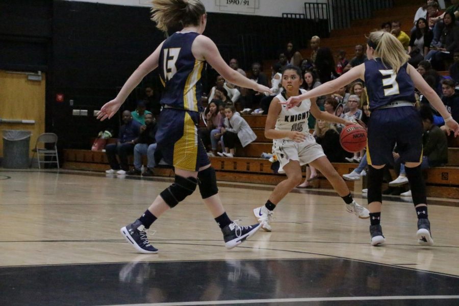 Sophia Guillermo (21) brings the ball to the three-point line.