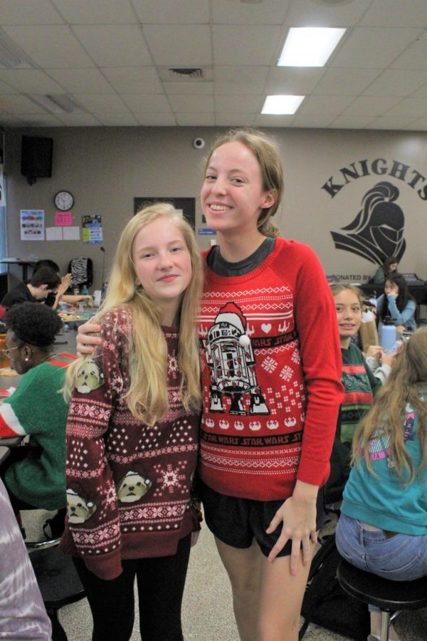 Lauren Yoakmun (23) and Kelsi White (23) show their different holiday sweaters.