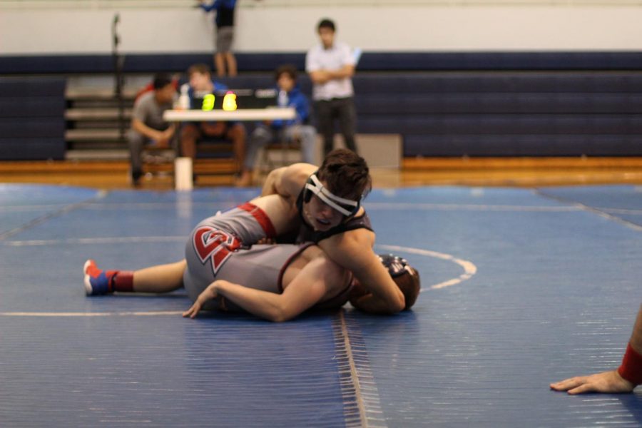 Thomas Green (21) puts Freedoms 132 pound weight wrestler in a half nelson to score a three point near fall.