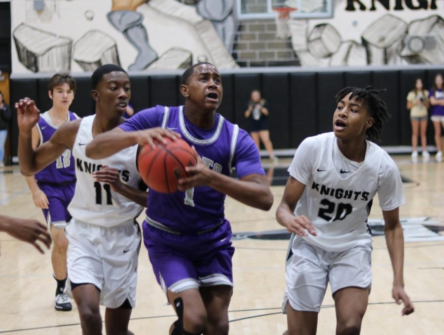 Dexter Caldwell (20) and Treyshawn Howard (22) chase down a Spoto player driving to the basket.