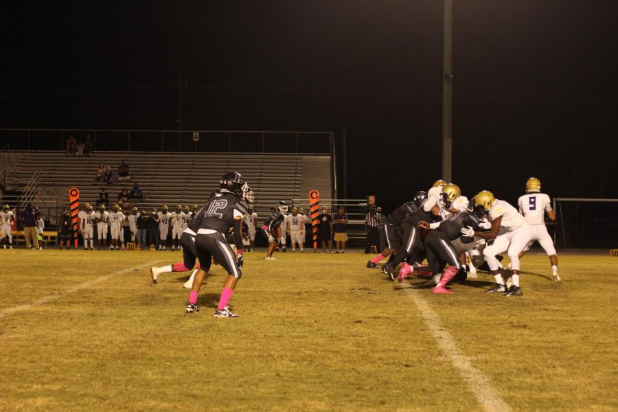 The Robinson Knights charge the football during the game against Booker, sporting pink socks and cleats for Pink Out for Breast Cancer Awareness Month.