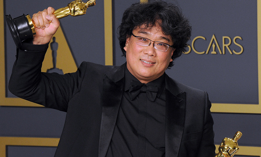 Director Bong Joon Ho shows off his Oscars won for the movie Parasite.
