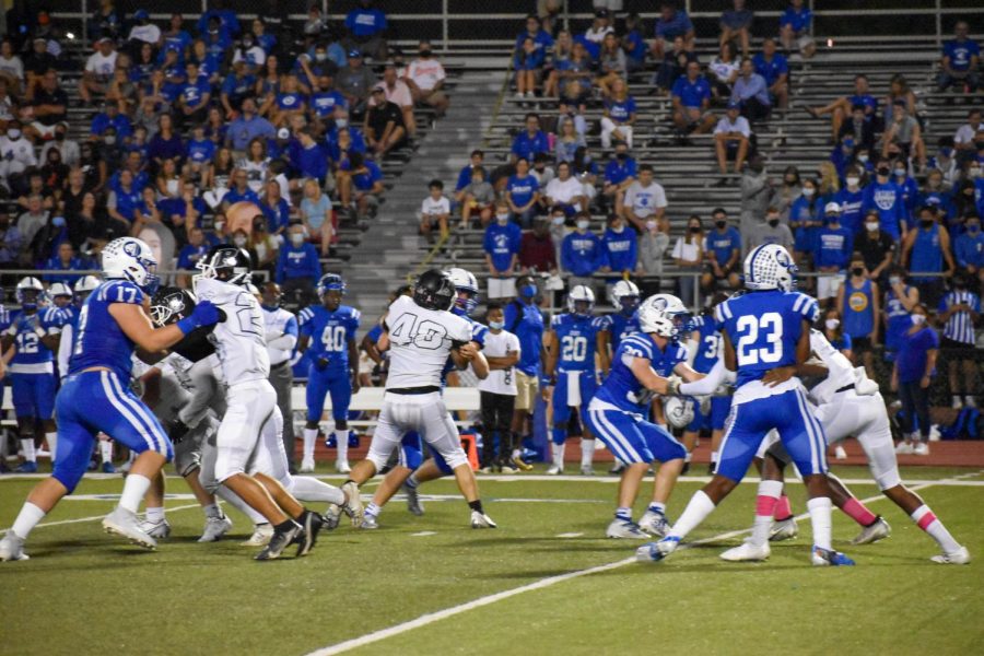 Robinson Knights play against the Jesuit Tigers, where spectators can clearly be seen in the background. 