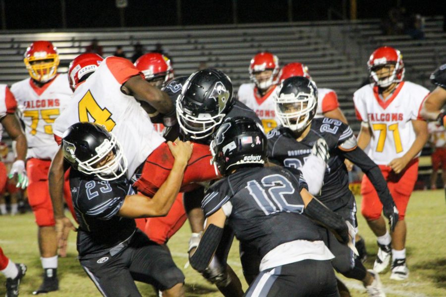 Cylas Brown (22) (left), Levi Mcaffee (21) (center) and Devin Collado (23) tackling a Leto running back.