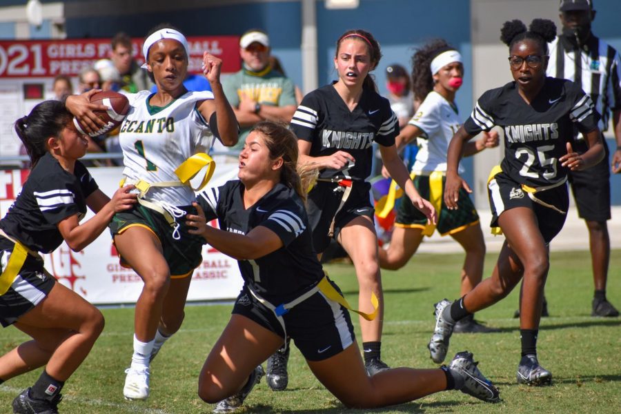 Guillermo and Courtney rip off the flag of the Lecanto player carrying the ball with Stasio and Rolack close by. 