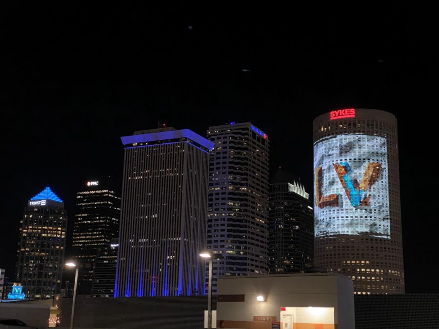 A Super Bowl LV ad projected onto a building in Downtown Tampa, as seen from the Super Bowl Experience.