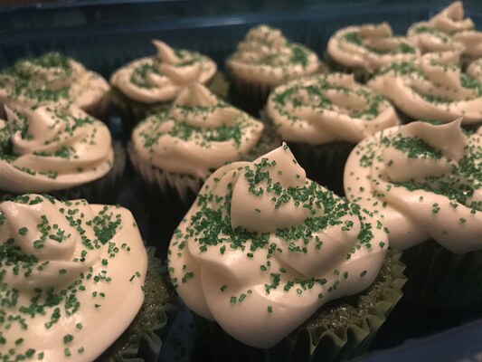 The finished green velvet cupcakes, with cream cheese frosting and sprinkles.