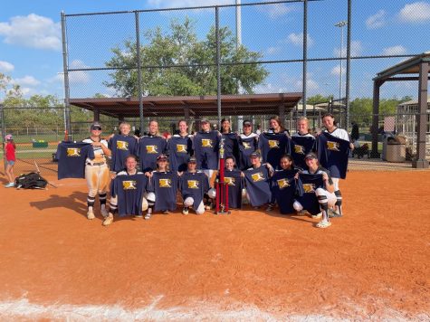 The softball team poses with their second place trophy and tee-shirts while they were at the Longshore Tournament. From April 16-17, the team played tough competition from across the state. 