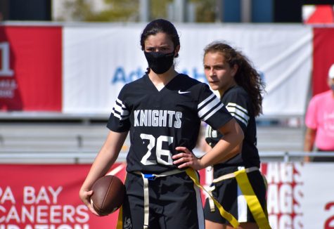 Bella Rodrigues (23)(front) wearing a mask during the annual Girls Flag Football Preseason Classic in a game against Lecanto. Prior to the end of the school year, she had already received both doses of the vaccine. Ill probably continue to wear a mask [during the school day] since there are a lot of people...but during sports, I dont think Ill wear it anymore since it was kind of uncomfortable to play with a mask on, Rodrigues said. 