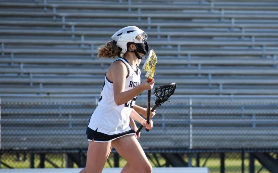 Issa Allbritton (23) chasing after the ball in a lacrosse game against Alonso in March. Allbritton continued wearing her mask not only off the field but during the game while playing. 
