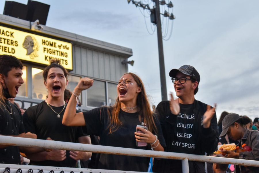 (From left to right) Gabe Guiteirrez-Sanchez (23), Diego Hernandez (23), Cassidy Chapman (23) and Alex Galvin (23) cheer on the Robinson marching band as they play in the stands. After being an eLearner for a year, I definitely missed the community feeling we have. I really missed the student sections school spirit. I definitely felt like Im really back at school now, Chapman said.