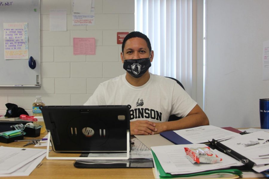 Sitting at his desk, Gerard Batista is all smiles in his second week of school.