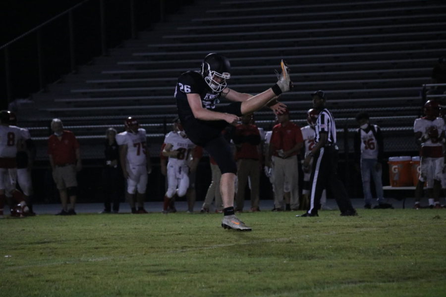 Robinson Knights kicker Gunnar Gibson (22) practicing his punts for the game against East Bay during halftime