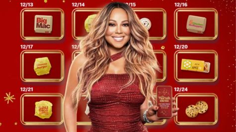 Mariah Carey poses in front of the rewards available in the McDonalds app.