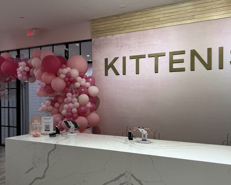 In the new Hyde Park store, Kittenish, you can see some of their logos displayed and what the check-out. Theres a space behind the pink balloons where you may snap photos with whoever youre shopping with.