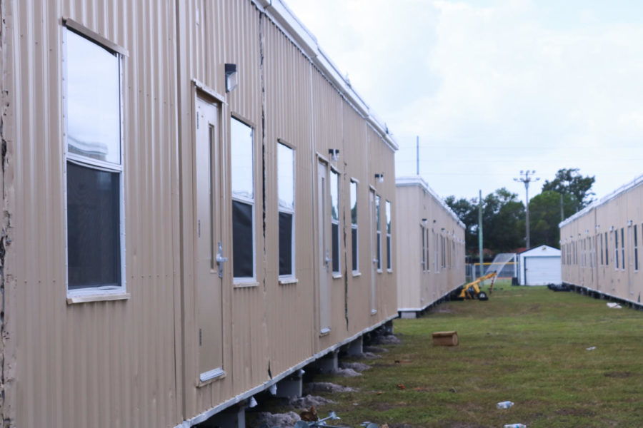 A row of portables. Outside of Robinson High School gates are lines of temporary classrooms. The construction team is working to prepare the classes for students by semester two of the 2021-2022 school year.